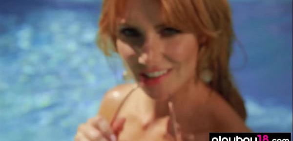 Stunning redhead MILF Gia Marie poses naked in the pool outdoor
